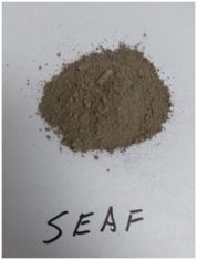 A pile of gray powder labeled "seaf" on a white surface.